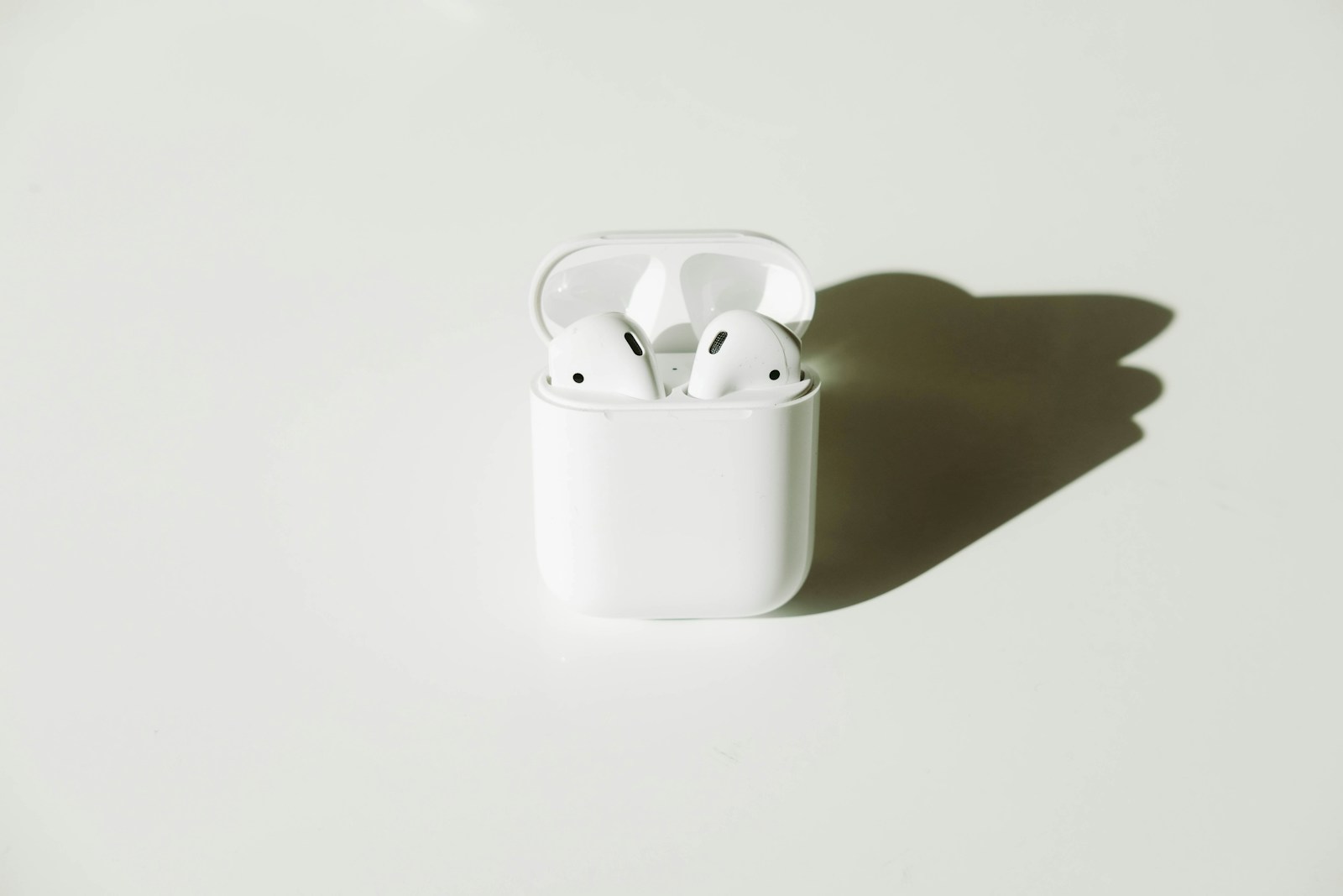 Illustrative stock photograph of wireless earbuds and their charging case.